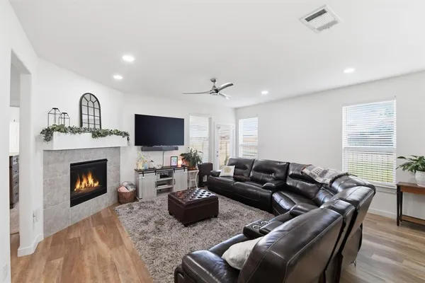 a living room with furniture flat screen tv and a fireplace