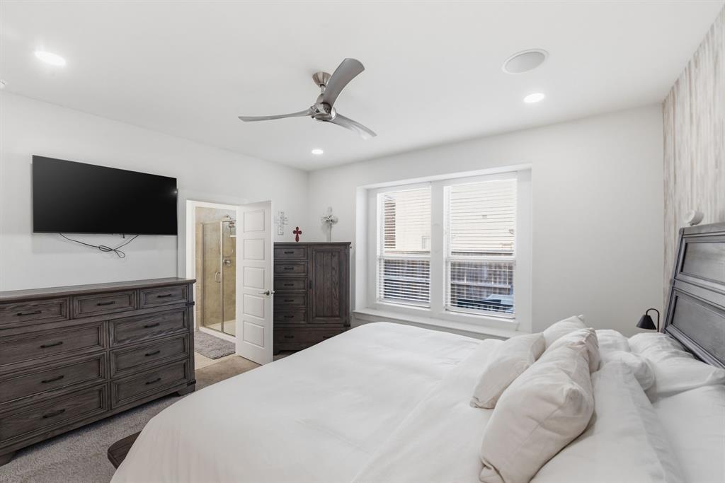 7645 Spring Drive Watauga, TX 76148 - Photo 19 of 28 a bedroom with a large bed and a flat screen tv