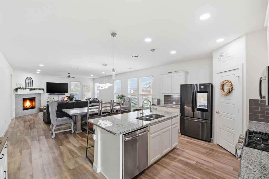 7645 Spring Drive Watauga, TX 76148 - Photo 2 of 28 a kitchen that has a lot of cabinets a sink and appliances
