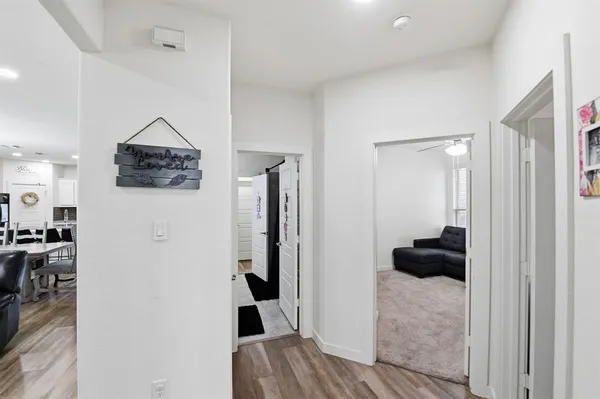 a room with a walk in closet and wooden floor