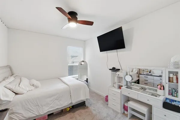 a bedroom with a bed and a flat screen tv