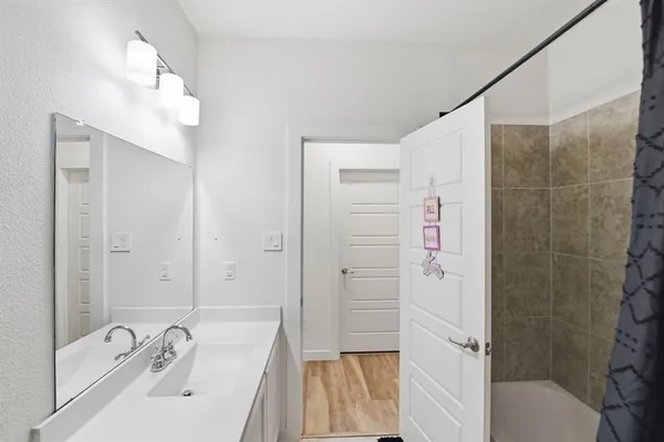 a bathroom with a sink a mirror and a bathtub