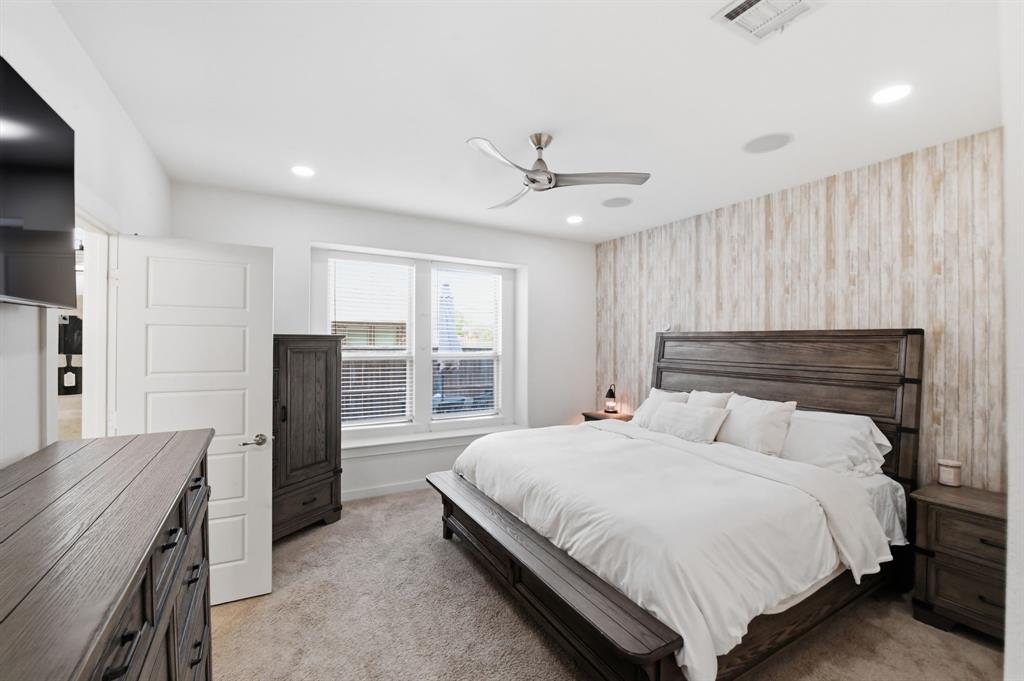 7645 Spring Drive Watauga, TX 76148 - Photo 4 of 28 a bedroom with a bed and a refrigerator