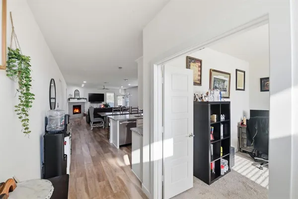 a kitchen view with furniture a refrigerator and a stove