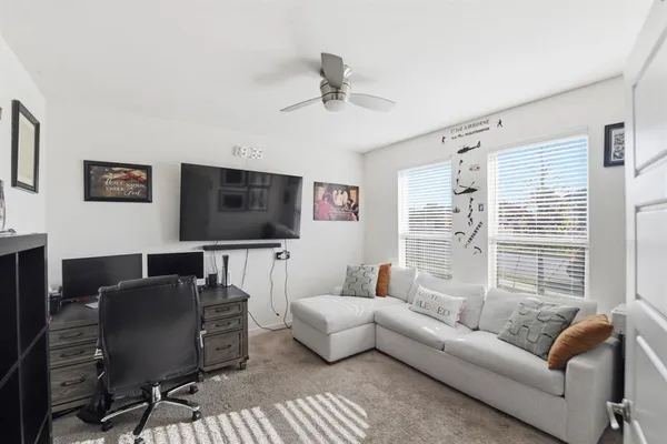 a living room with furniture and a flat screen tv
