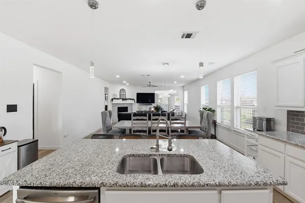 a kitchen with granite countertop a sink and a counter top space