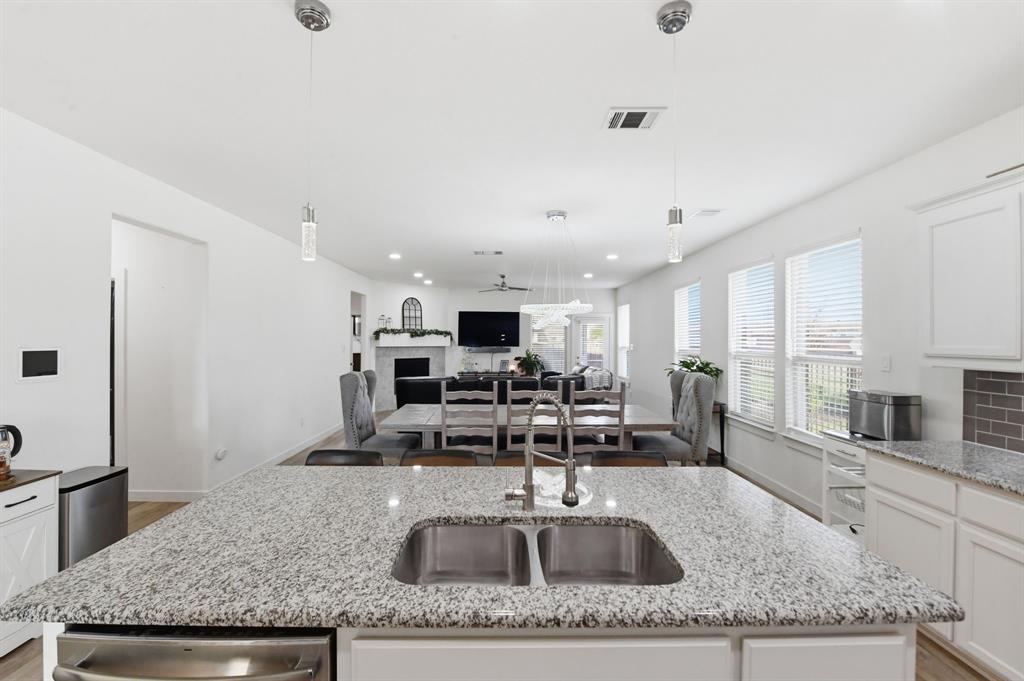 7645 Spring Drive Watauga, TX 76148 - Photo 9 of 28 a kitchen with granite countertop a sink and a counter top space
