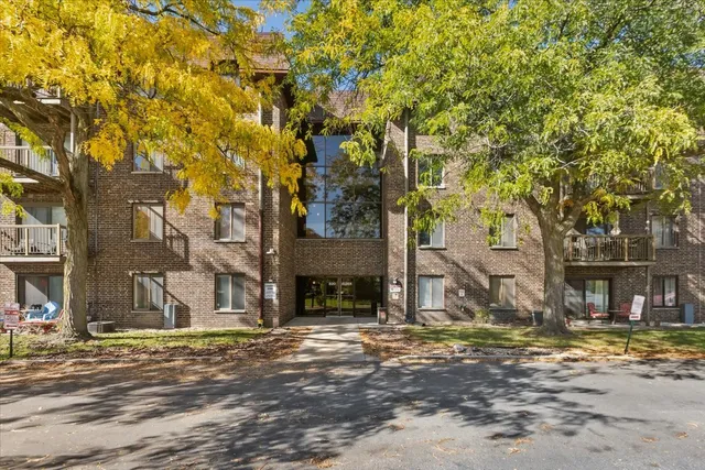 a view of a house with a tree in front