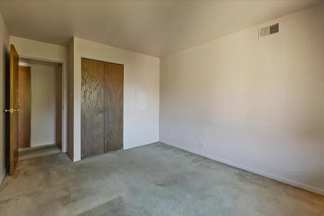 an empty room with closet area
