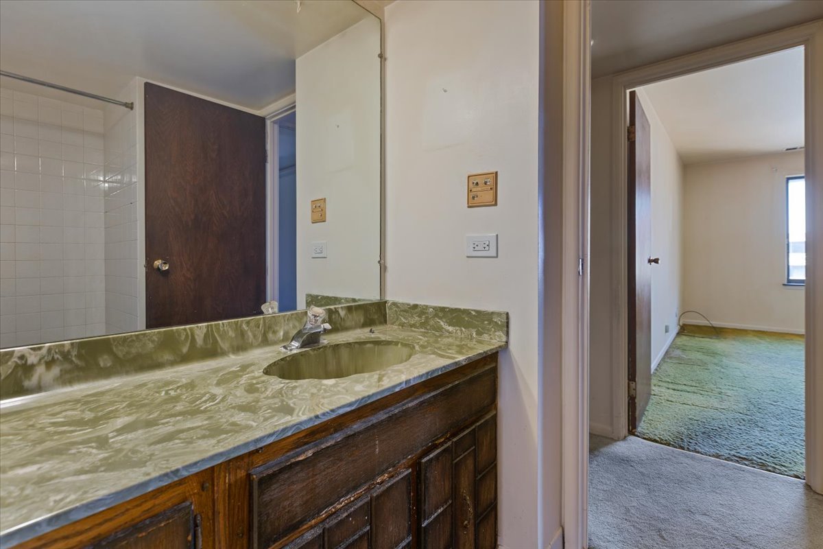 820 Elder Road, Unit C410 Homewood, IL 60430 - Photo 16 of 19 a bathroom with a granite countertop sink and a mirror
