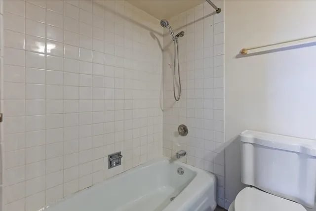 a bathroom with a toilet and shower
