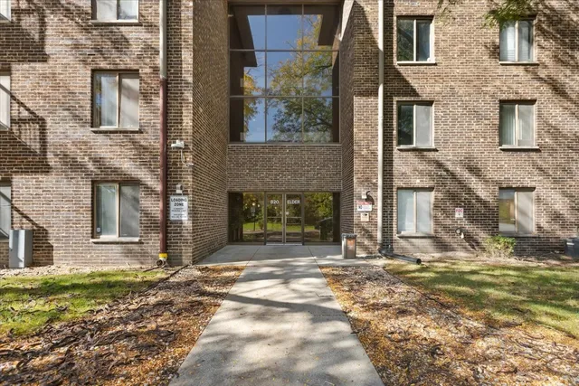 a view of a brick house with many windows