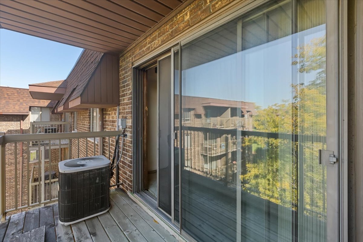 820 Elder Road, Unit C410 Homewood, IL 60430 - Photo 3 of 19 a view of a balcony with chair and the glass door