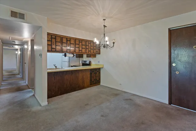 a view of a hallway with a chandelier