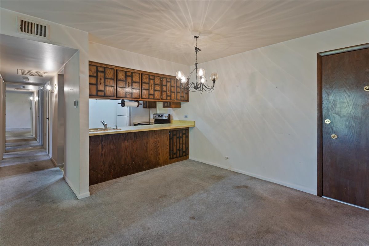 820 Elder Road, Unit C410 Homewood, IL 60430 - Photo 7 of 19 a view of a hallway with a chandelier