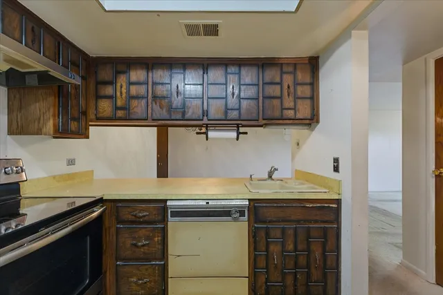 a kitchen with stainless steel appliances granite countertop a sink and a stove