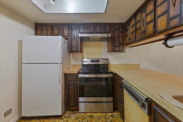 a kitchen with a refrigerator and a stove