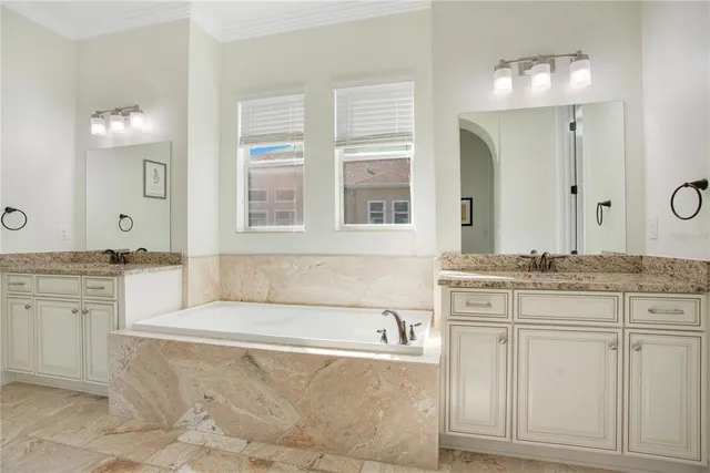 a spacious bathroom with a granite countertop sink and a mirror