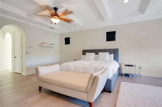 a bedroom with a bed and a ceiling fan