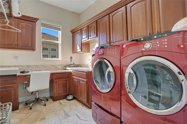 a utility room with sink dryer and washer