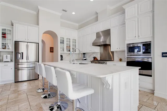 a kitchen with stainless steel appliances a refrigerator sink and stove