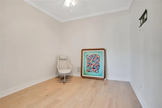 an entryway with painting on wall and wooden floor