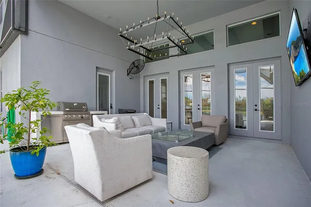 a living room with furniture and a chandelier
