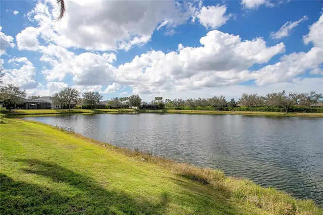 a view of a lake with houses in the background