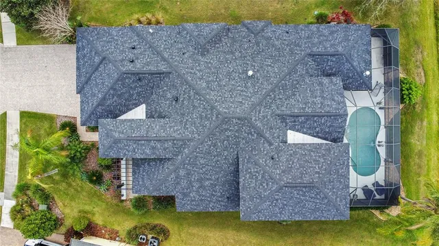 a aerial view of a house with pool and plants