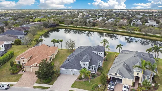 an aerial view of a house with a lake view