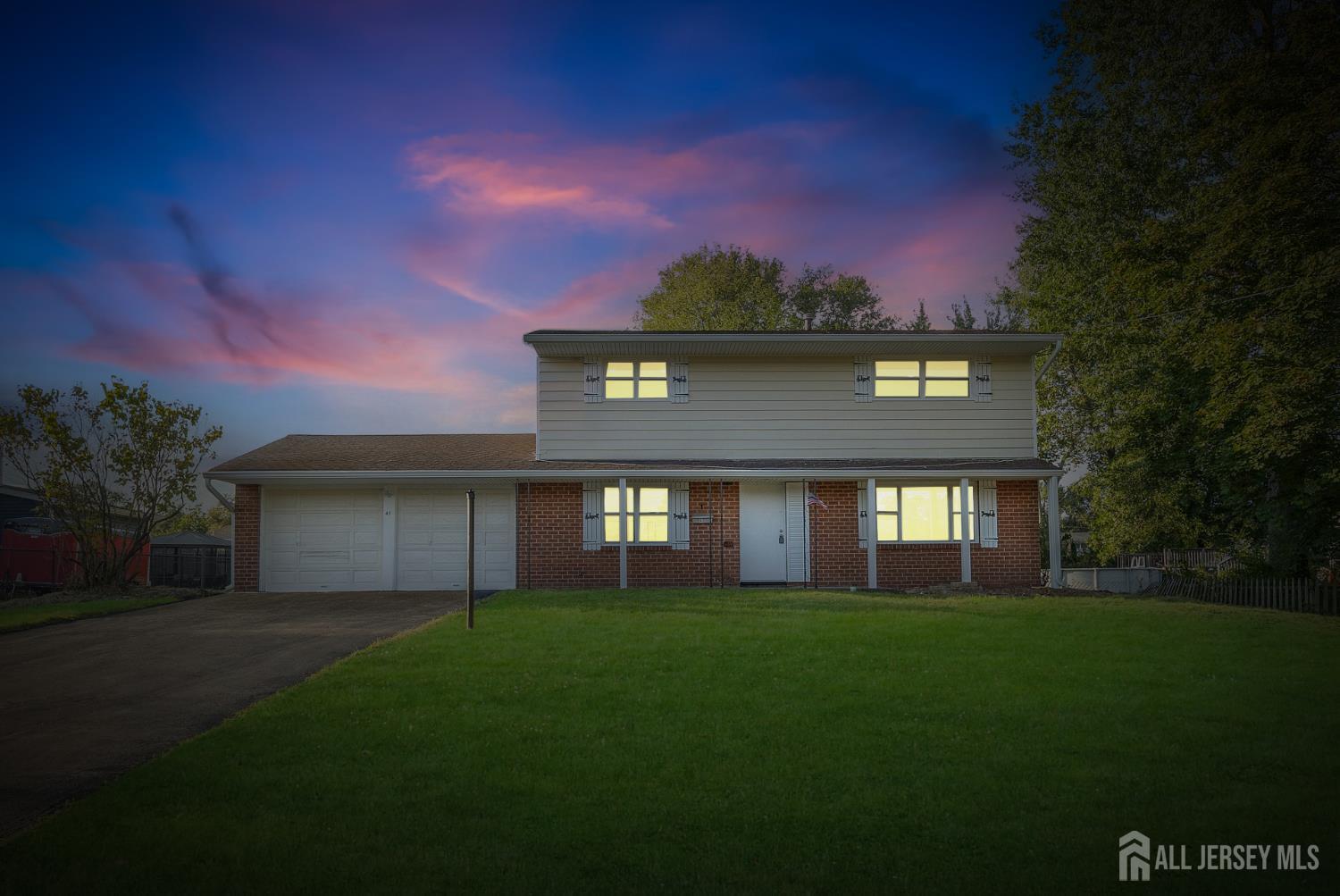 a front view of a house with a garden and yard