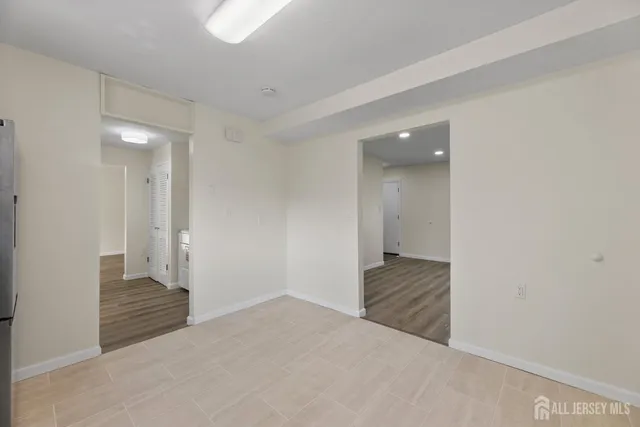a view of an empty room and wooden floor
