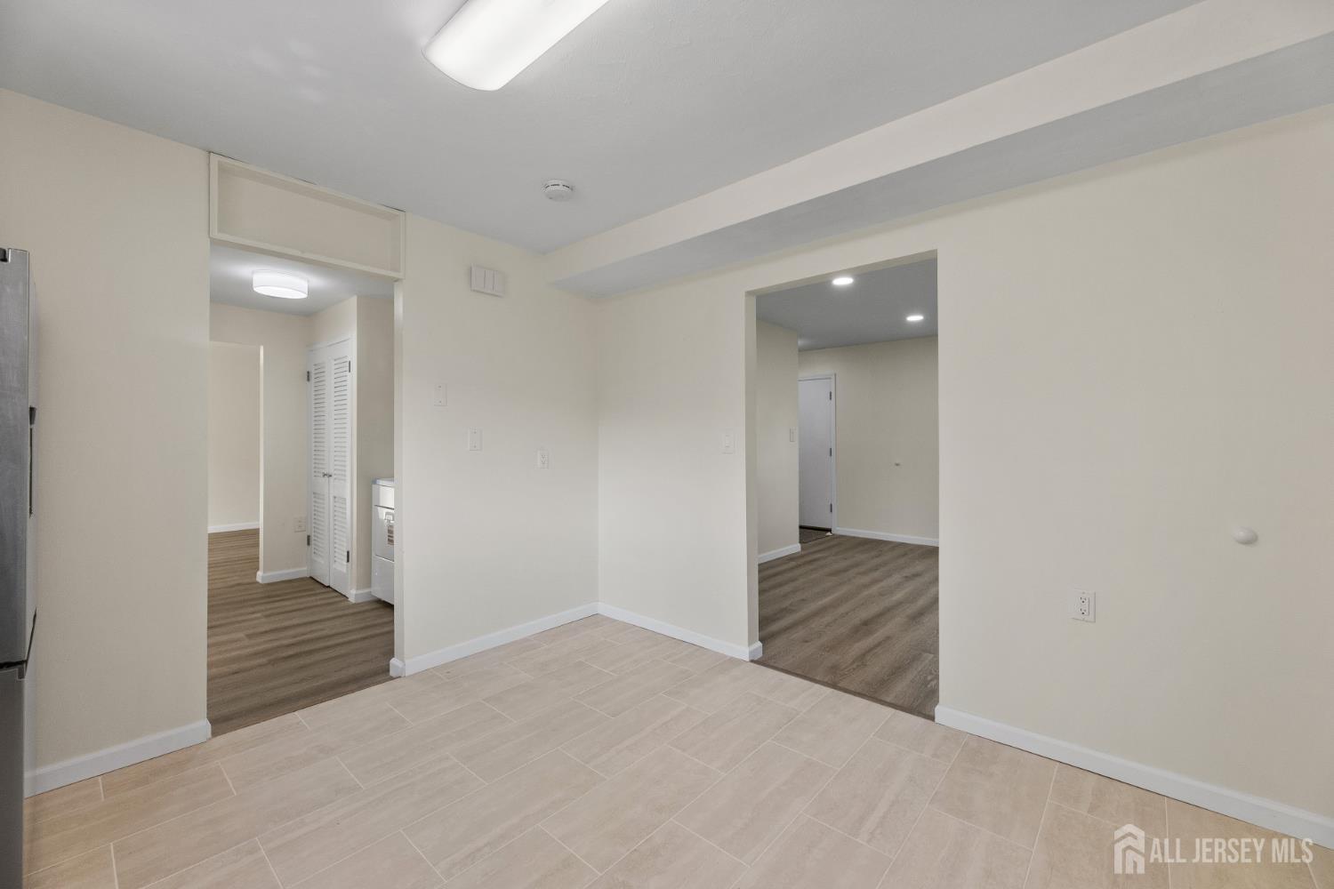 41 Raleigh Road Kendall Park, NJ 08824 - Photo 13 of 40 a view of an empty room and wooden floor