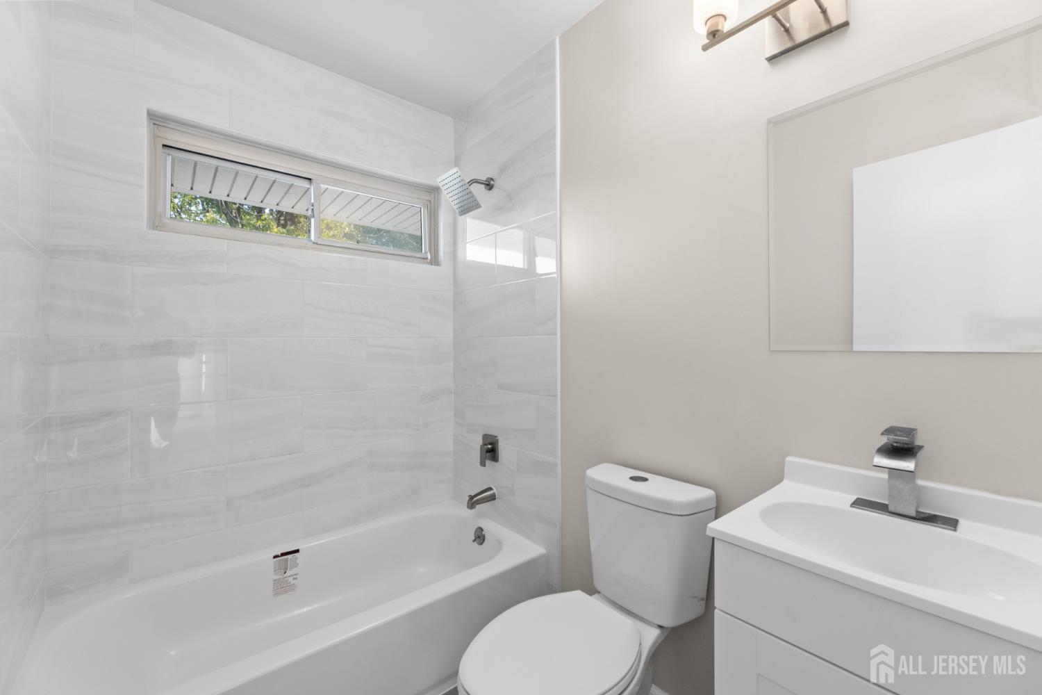 41 Raleigh Road Kendall Park, NJ 08824 - Photo 20 of 40 a bathroom with a sink a toilet and shower