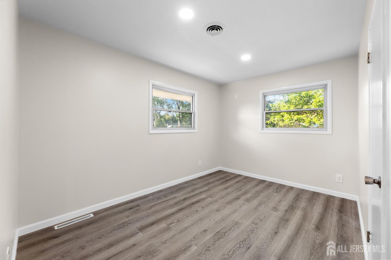 41 Raleigh Road Kendall Park, NJ 08824 - Photo 22 of 40 an empty room with windows and painting on the wall