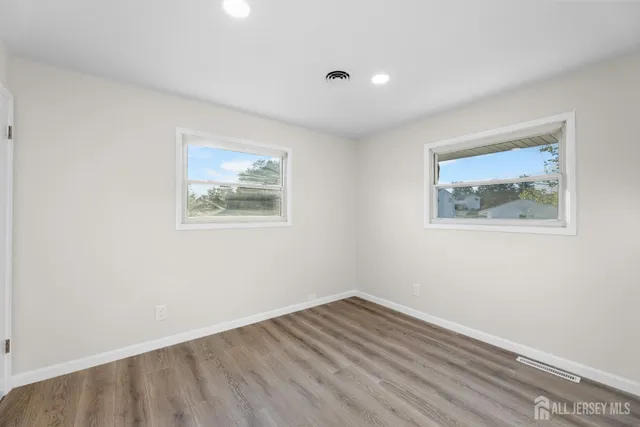 a view of room with wooden floor and window