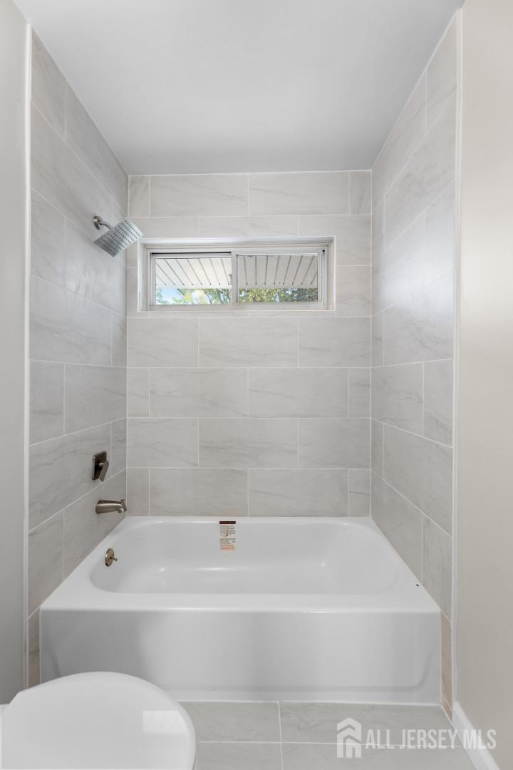 41 Raleigh Road Kendall Park, NJ 08824 - Photo 26 of 40 a bathroom with a bathtub and a shower