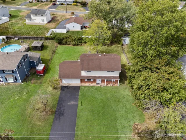 an aerial view of a house with garden space and street view