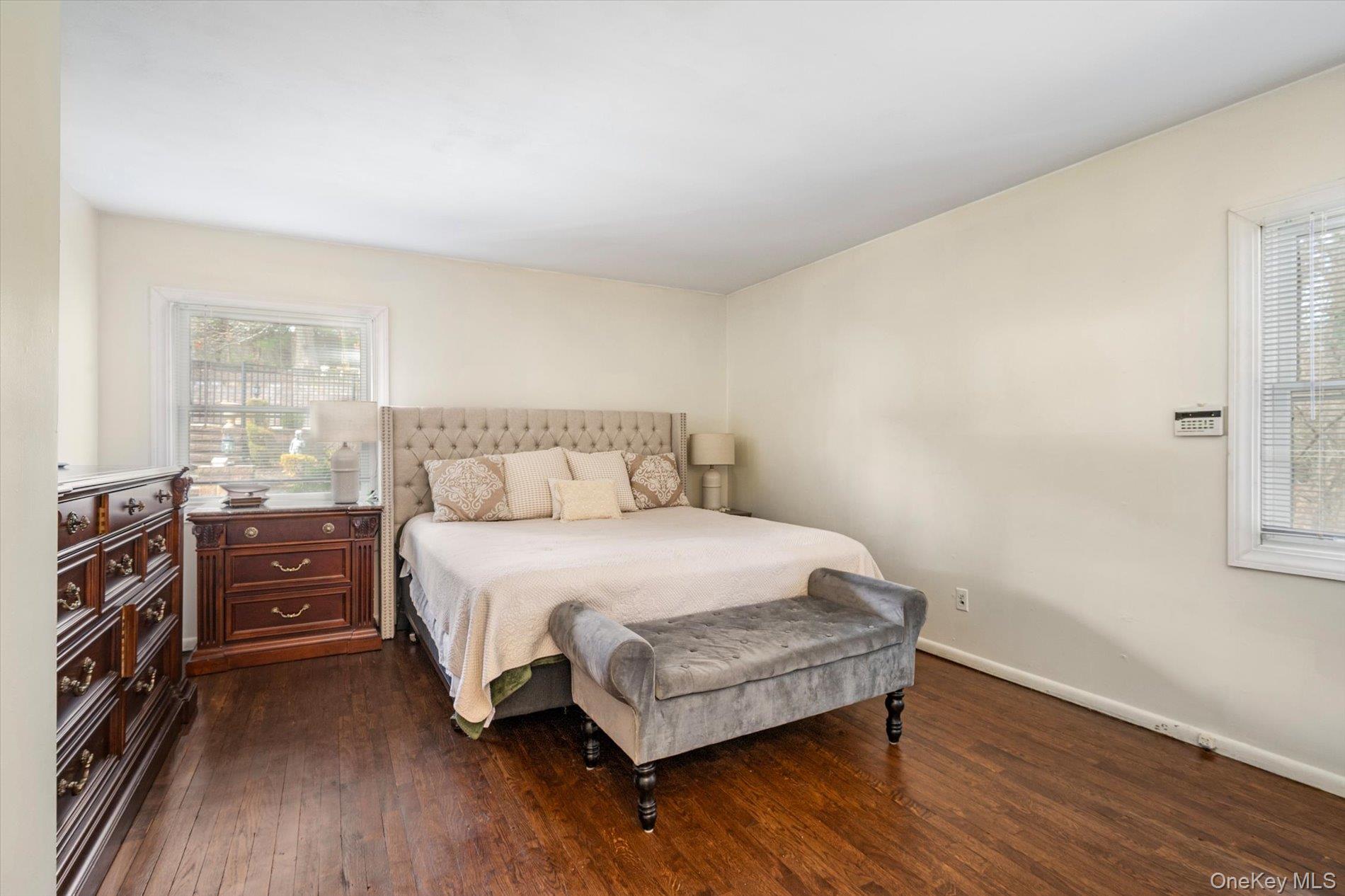 60 Ridge Drive Plainview, NY 11803 - Photo 14 of 27 a bedroom with a bed and wooden floor