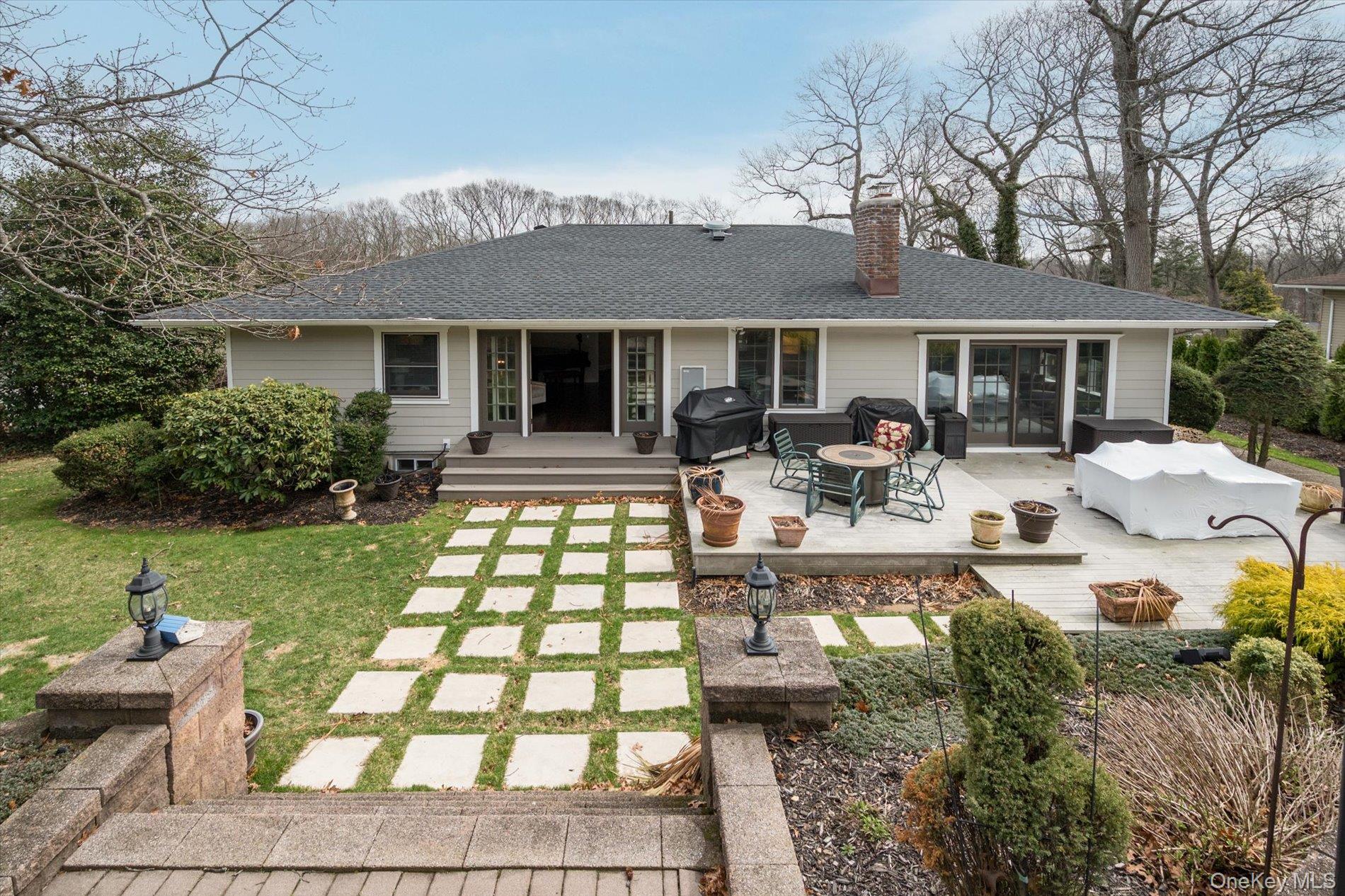 60 Ridge Drive Plainview, NY 11803 - Photo 20 of 27 a front view of a house with garden and patio