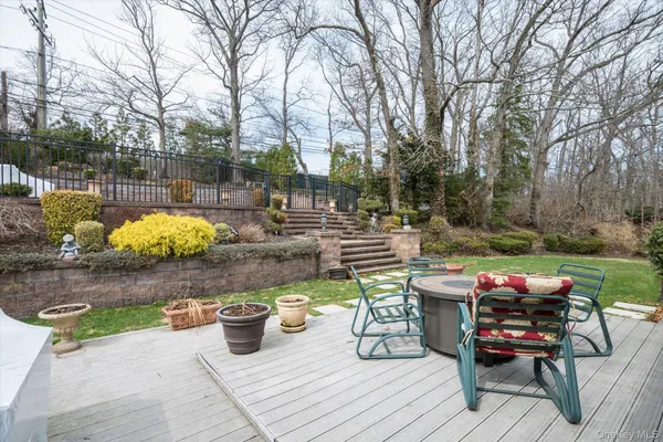 a view of a patio with table and chairs and potted plants
