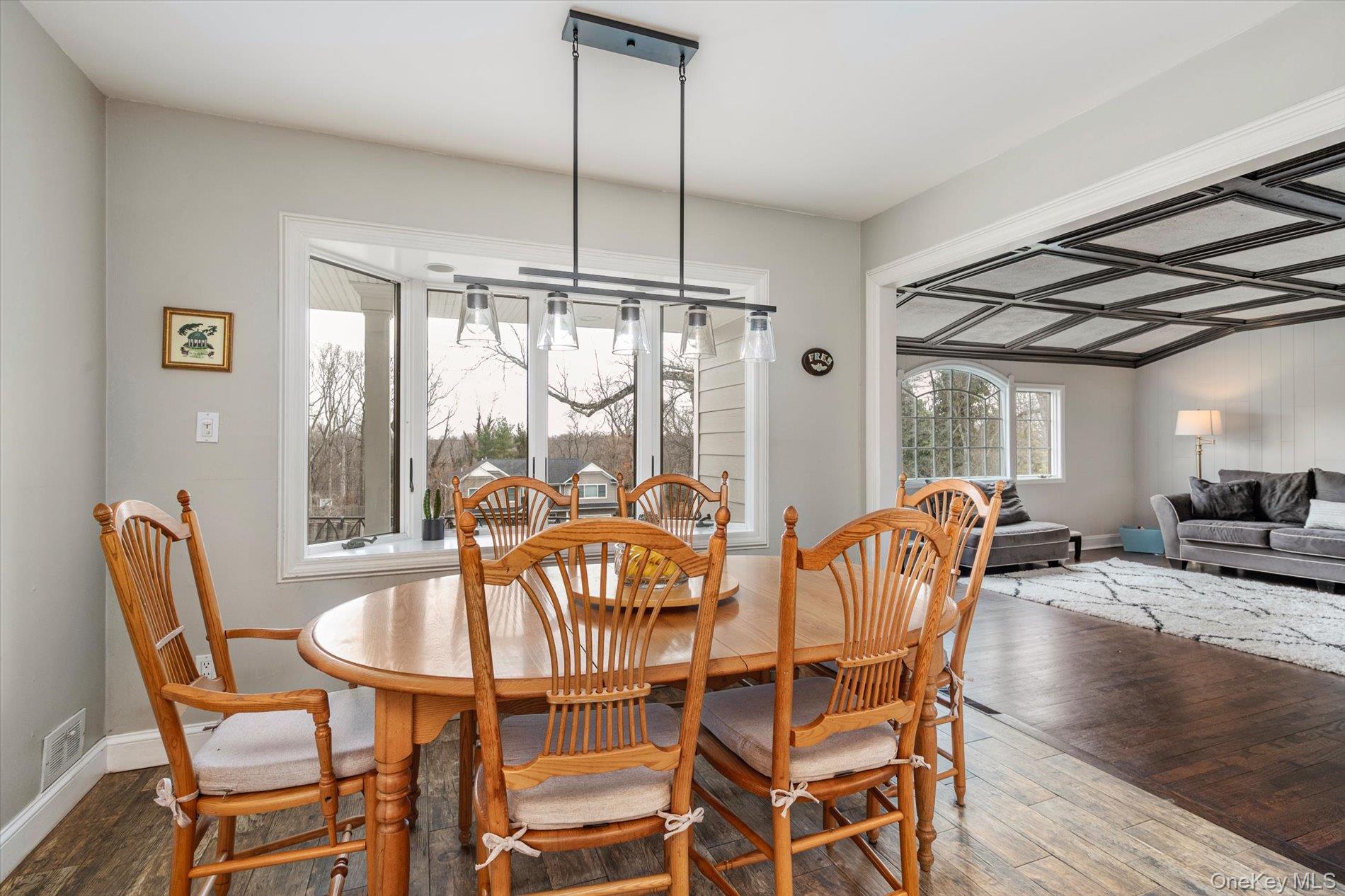 60 Ridge Drive Plainview, NY 11803 - Photo 8 of 27 a dining room with furniture a chandelier and wooden floor