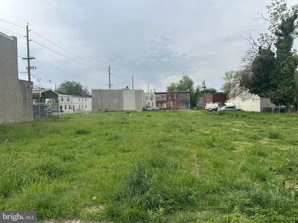 a view of a house with a big yard and large trees