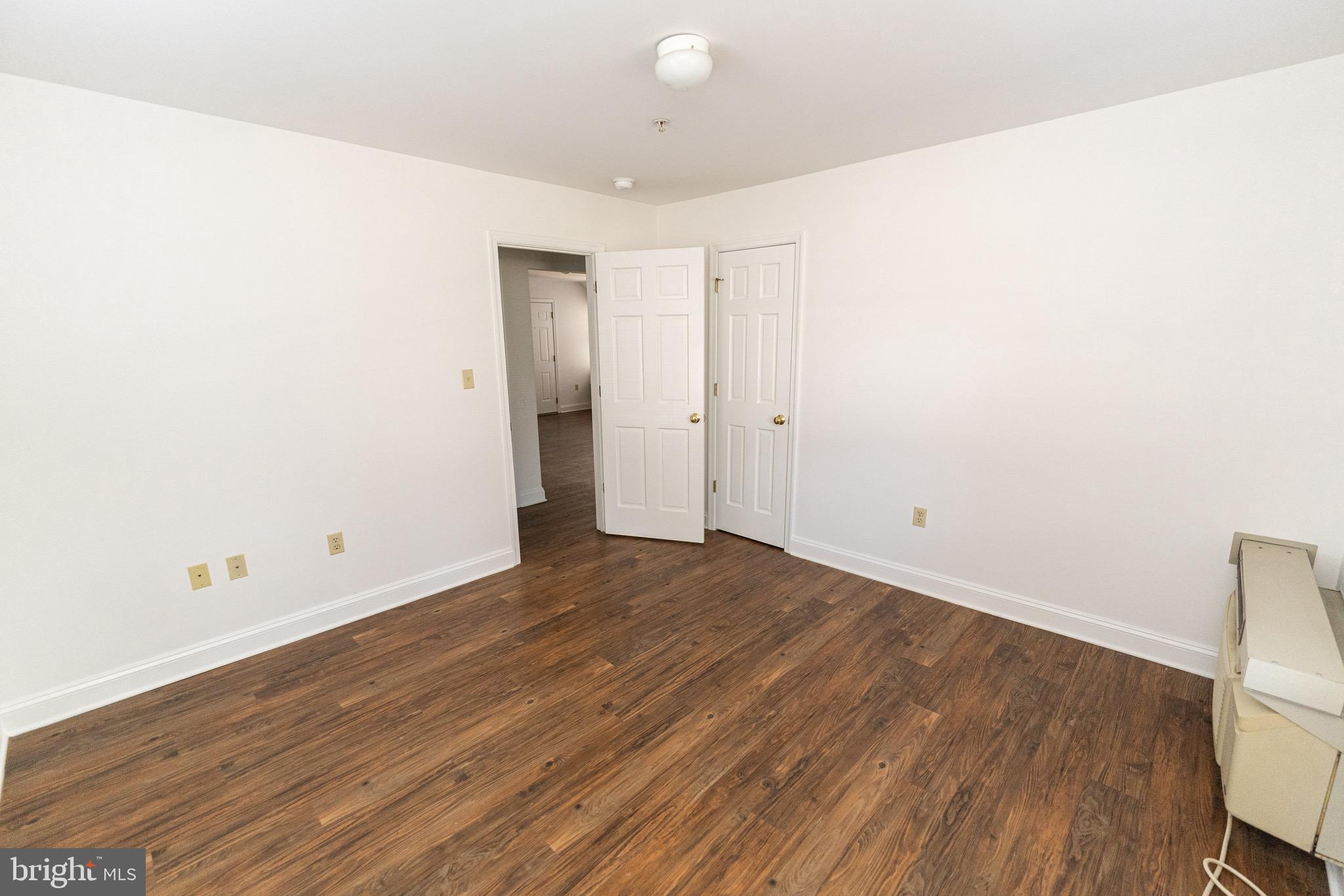804 Travers Street, Unit 2 Cambridge, MD 21613 - Photo 24 of 26 a view of a room with wooden floor and white walls