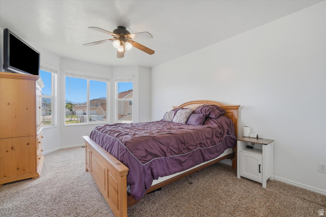 5576 South 4100th Street West Roy, UT 84067 - Photo 18 of 35 Primary bedroom with boxed windows and ceiling fan