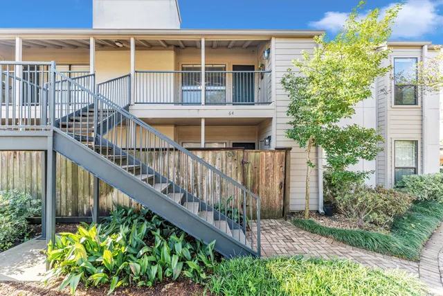 a view of a house with wooden fence