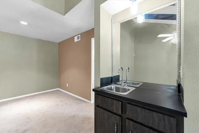 a bathroom with a sink a vanity and a mirror