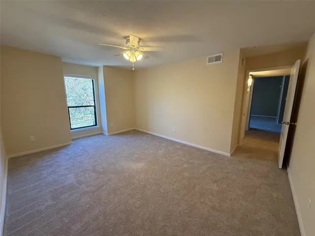 a view of a hallway with closet and wooden floor