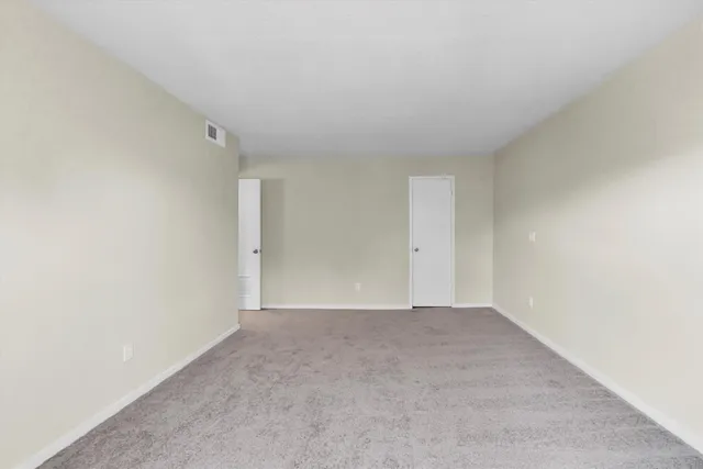 a view of a yard with wooden fence