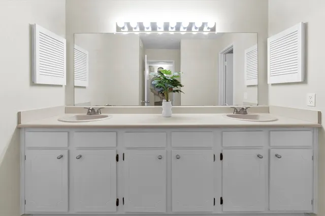 a white toilet sitting next to a white wall